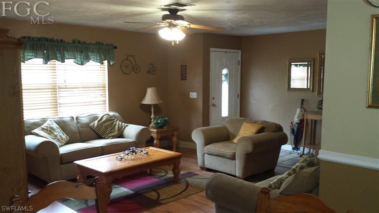 7436 Pebble Beach Road Fort Myers, FL 33967 - Photo 5 of 17 a living room with furniture and a large window