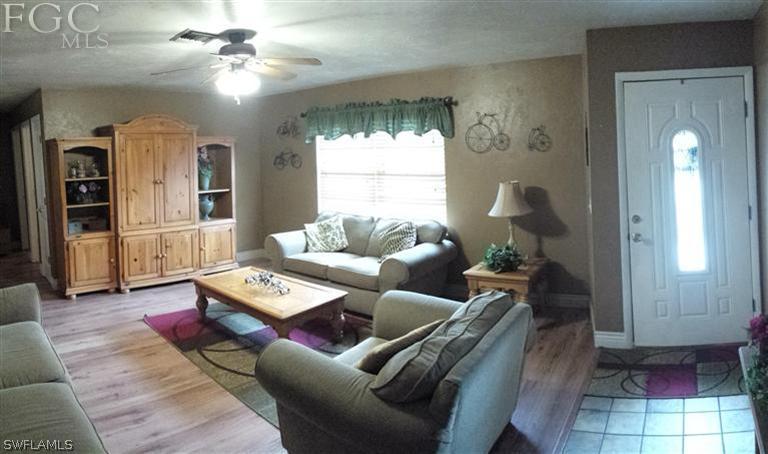 7436 Pebble Beach Road Fort Myers, FL 33967 - Photo 8 of 17 a living room with furniture and a chandelier