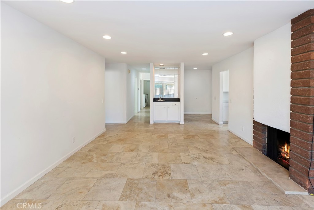 17241 Candleberry Irvine, CA 92612 - Photo 5 of 10 a view of an empty room with a fireplace