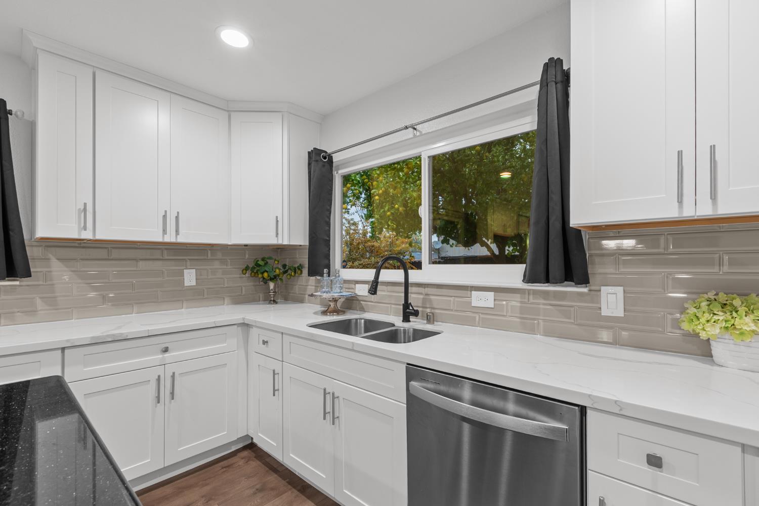 7135 Mathis Court Citrus Heights, CA 95610 - Photo 15 of 39 a kitchen with white cabinets and a window