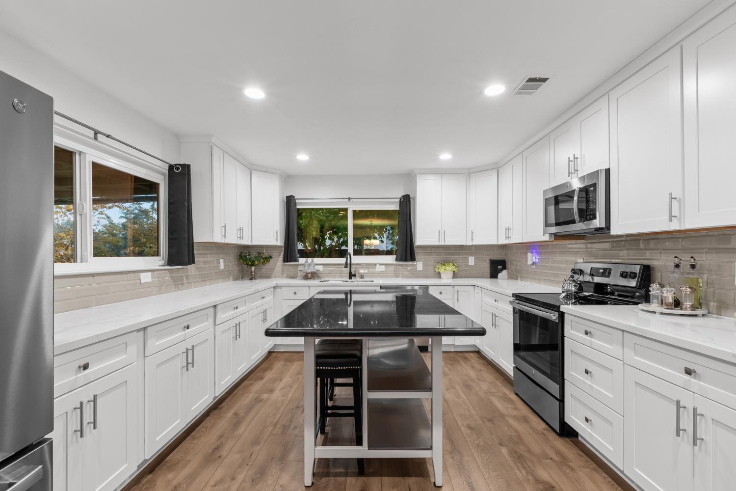 7135 Mathis Court Citrus Heights, CA 95610 - Photo 17 of 39 a kitchen with stainless steel appliances granite countertop white cabinets sink stove and microwave