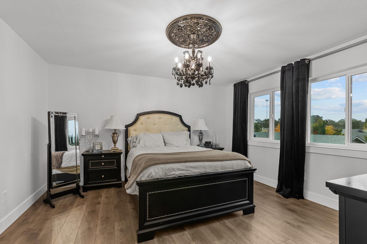 7135 Mathis Court Citrus Heights, CA 95610 - Photo 21 of 39 a bedroom with a bed and a chandelier