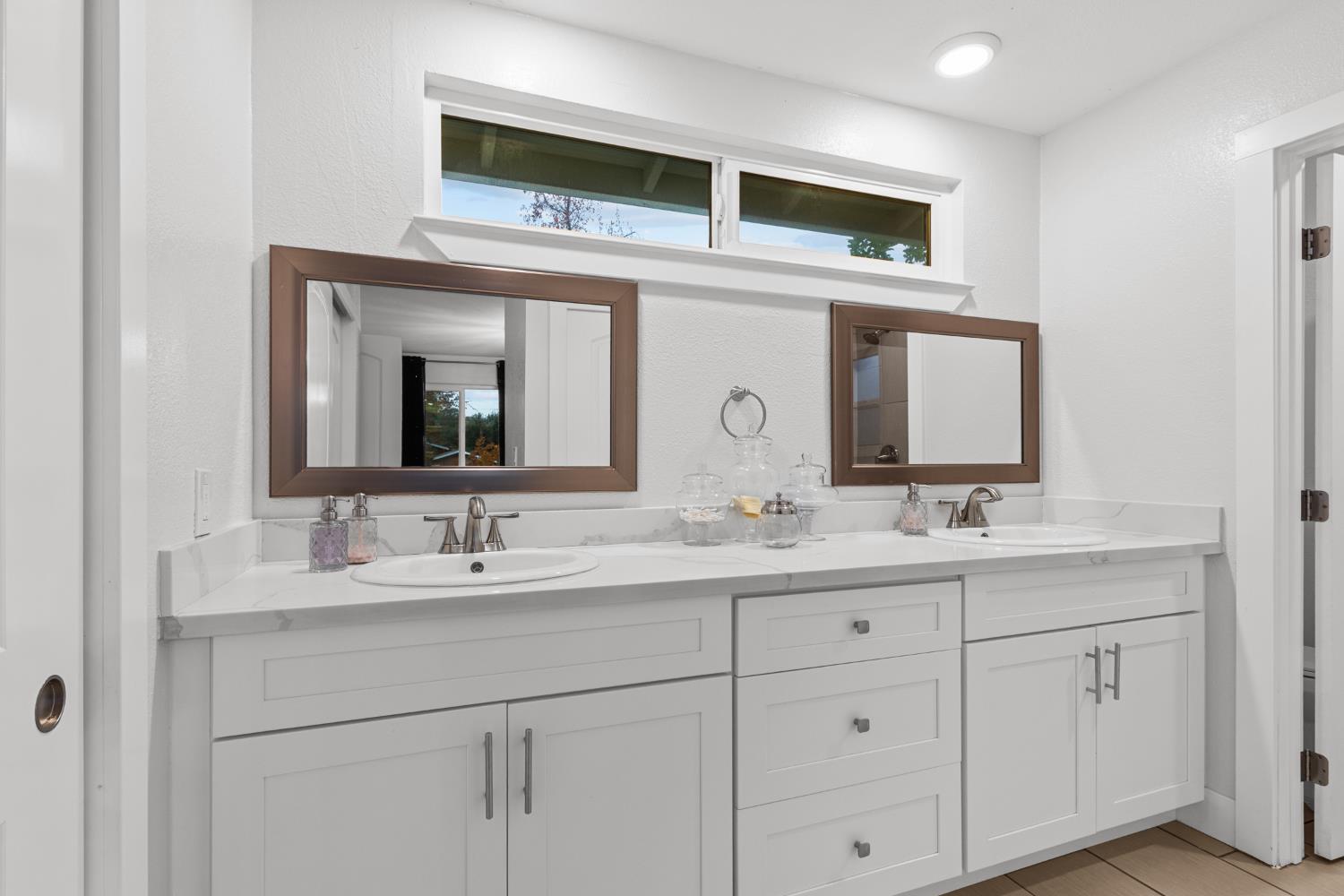 7135 Mathis Court Citrus Heights, CA 95610 - Photo 22 of 39 a bathroom with a double vanity sink and a mirror