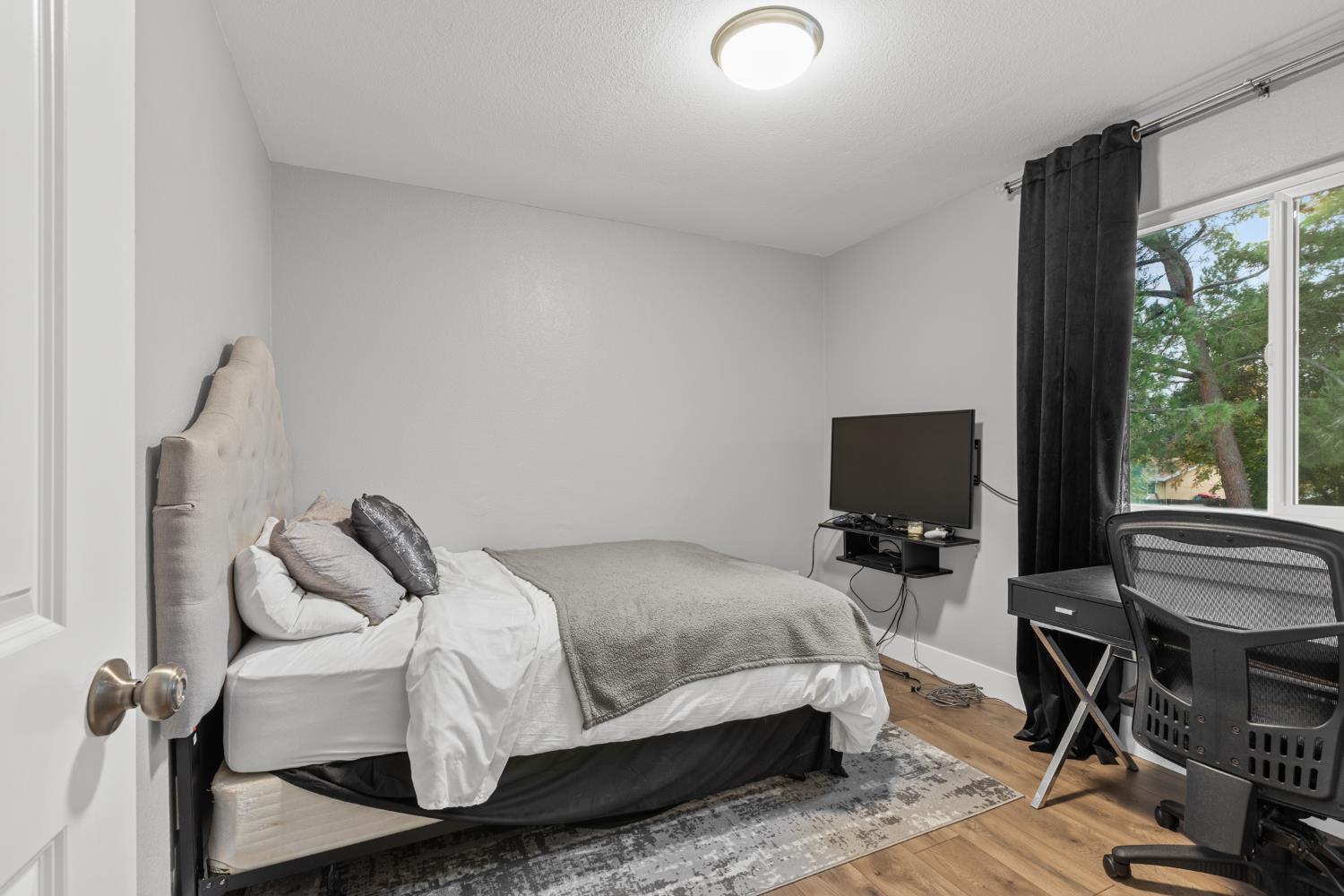 7135 Mathis Court Citrus Heights, CA 95610 - Photo 28 of 39 a bedroom with a bed and large windows