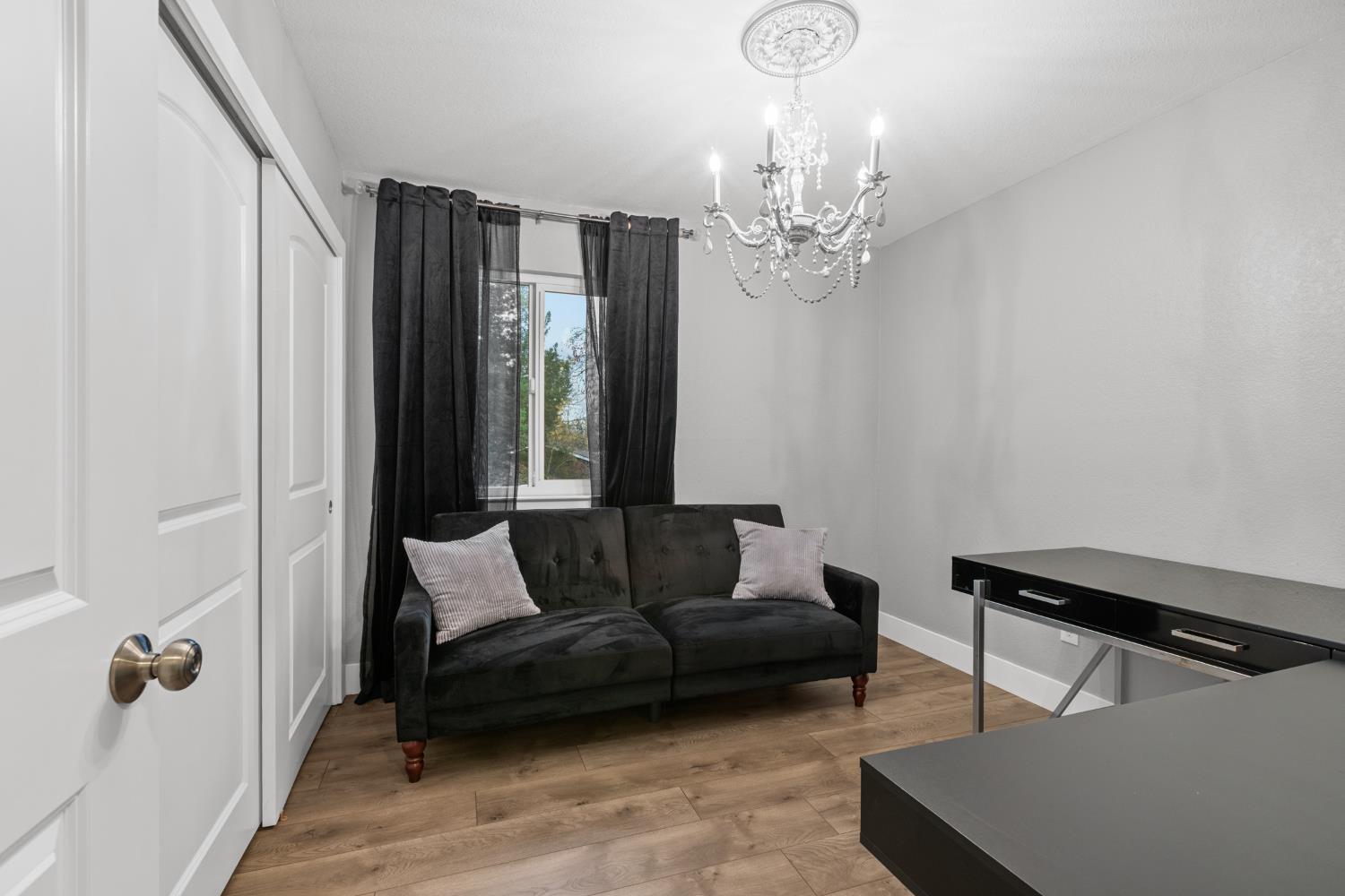 7135 Mathis Court Citrus Heights, CA 95610 - Photo 30 of 39 a living room with furniture and a chandelier