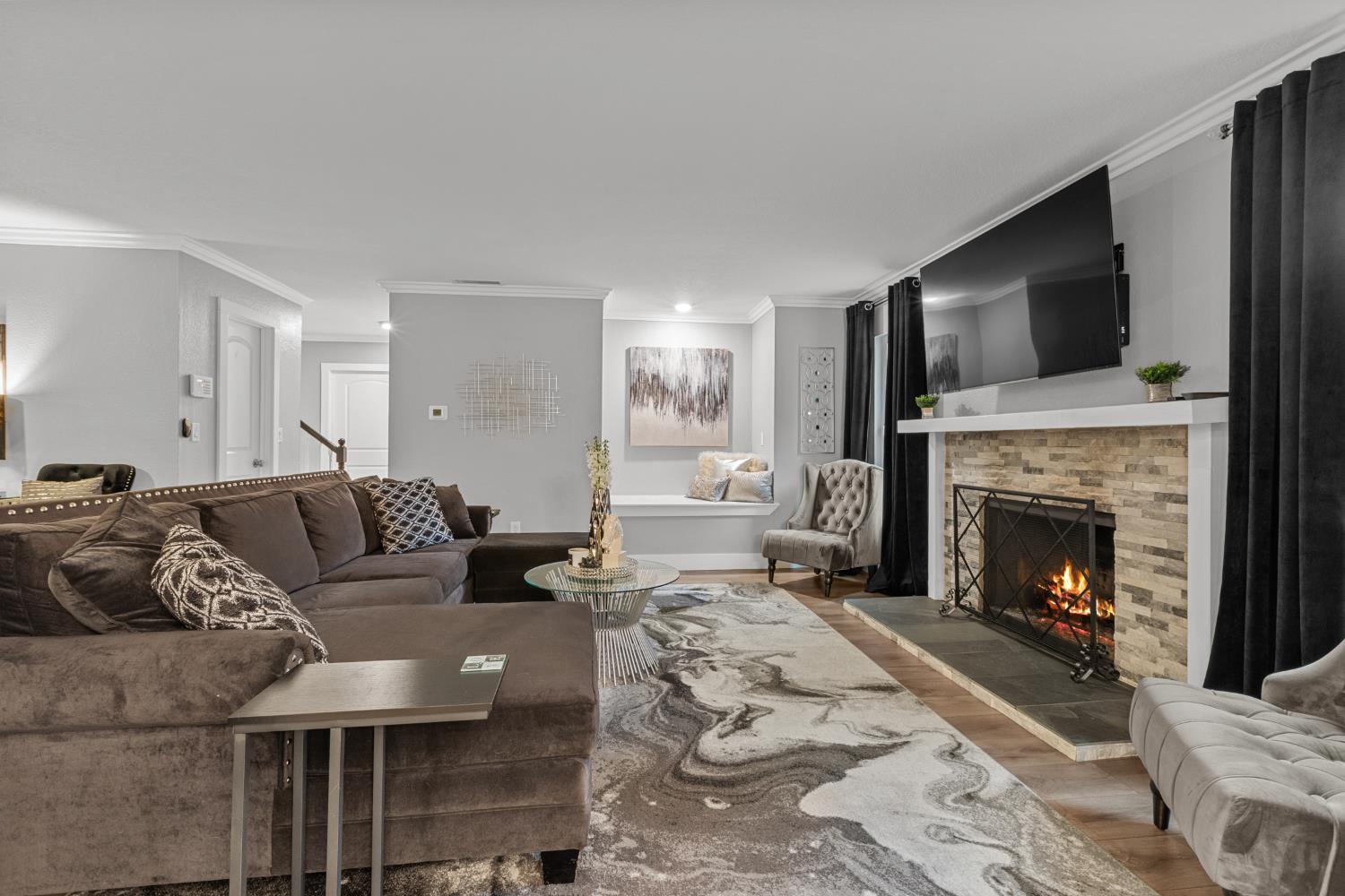 7135 Mathis Court Citrus Heights, CA 95610 - Photo 10 of 39 a living room with furniture a flat screen tv and a fireplace