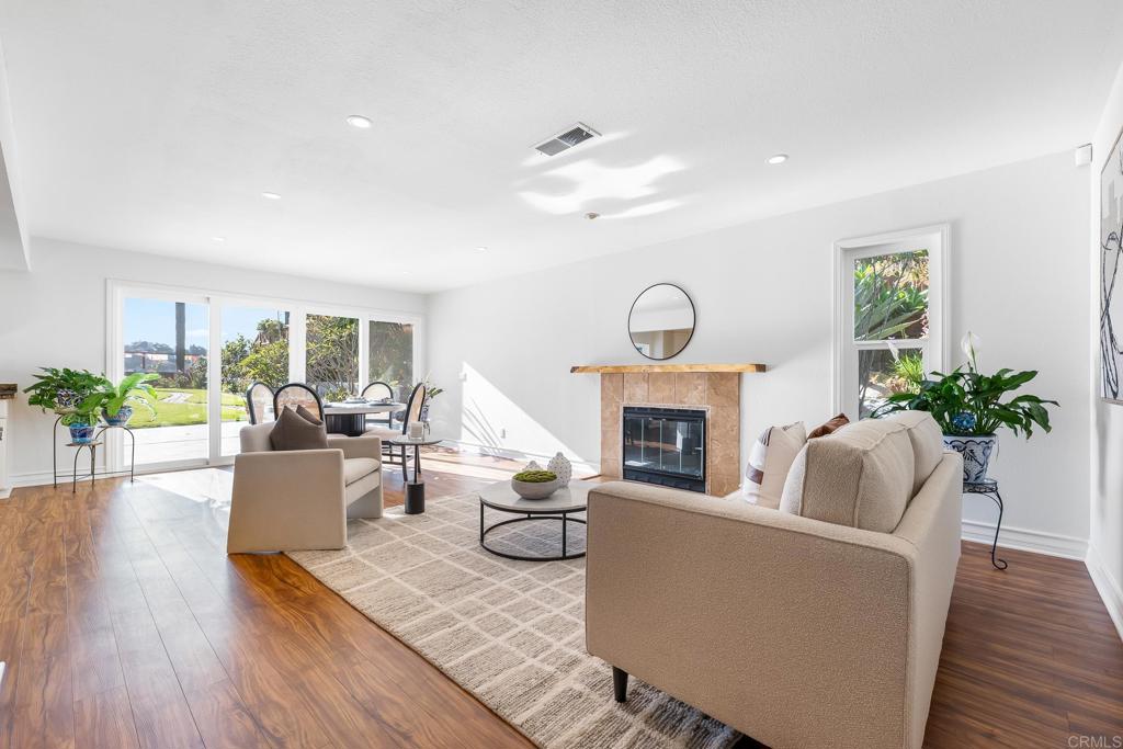 1592 Hawk View Drive Encinitas, CA 92024 - Photo 11 of 55 a living room with furniture a fireplace and a potted plant