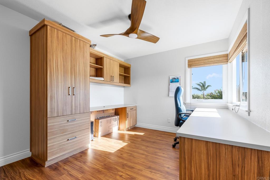 1592 Hawk View Drive Encinitas, CA 92024 - Photo 15 of 55 a view of a livingroom with wooden floor and a ceiling fan