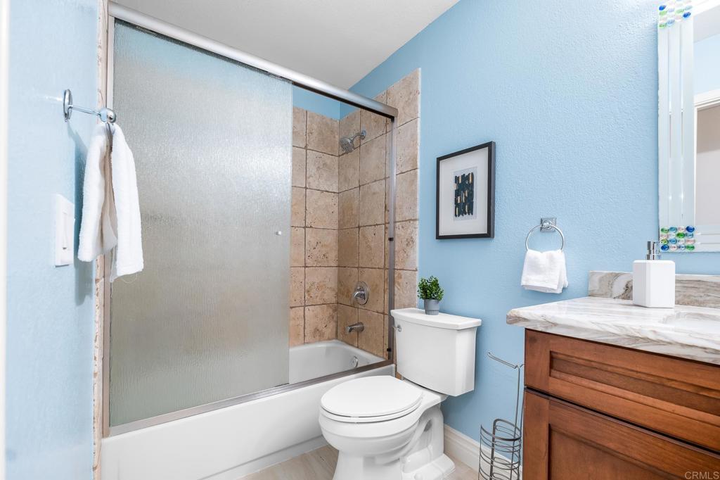1592 Hawk View Drive Encinitas, CA 92024 - Photo 19 of 55 a bathroom with a granite countertop sink toilet and shower