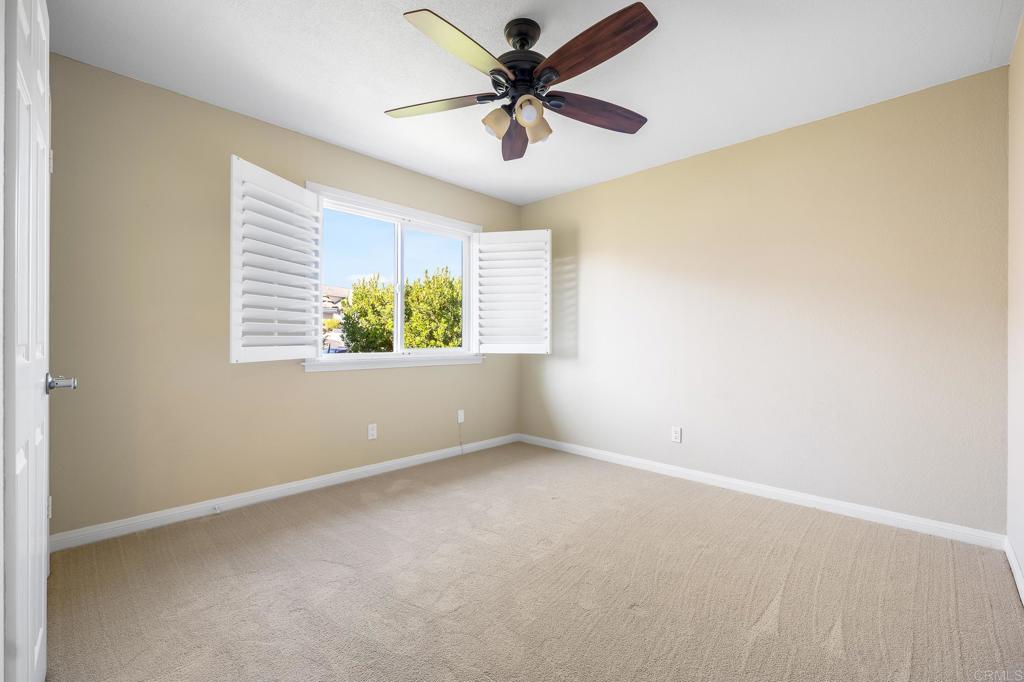 1592 Hawk View Drive Encinitas, CA 92024 - Photo 20 of 55 an empty room with windows and fan