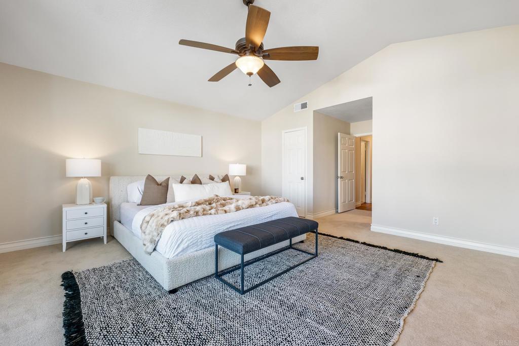 1592 Hawk View Drive Encinitas, CA 92024 - Photo 24 of 55 a spacious bedroom with a bed and a chandelier