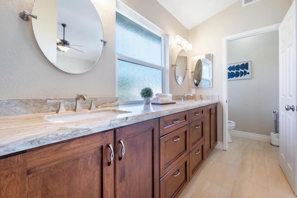 1592 Hawk View Drive Encinitas, CA 92024 - Photo 26 of 55 a bathroom with a double vanity sink and a mirror