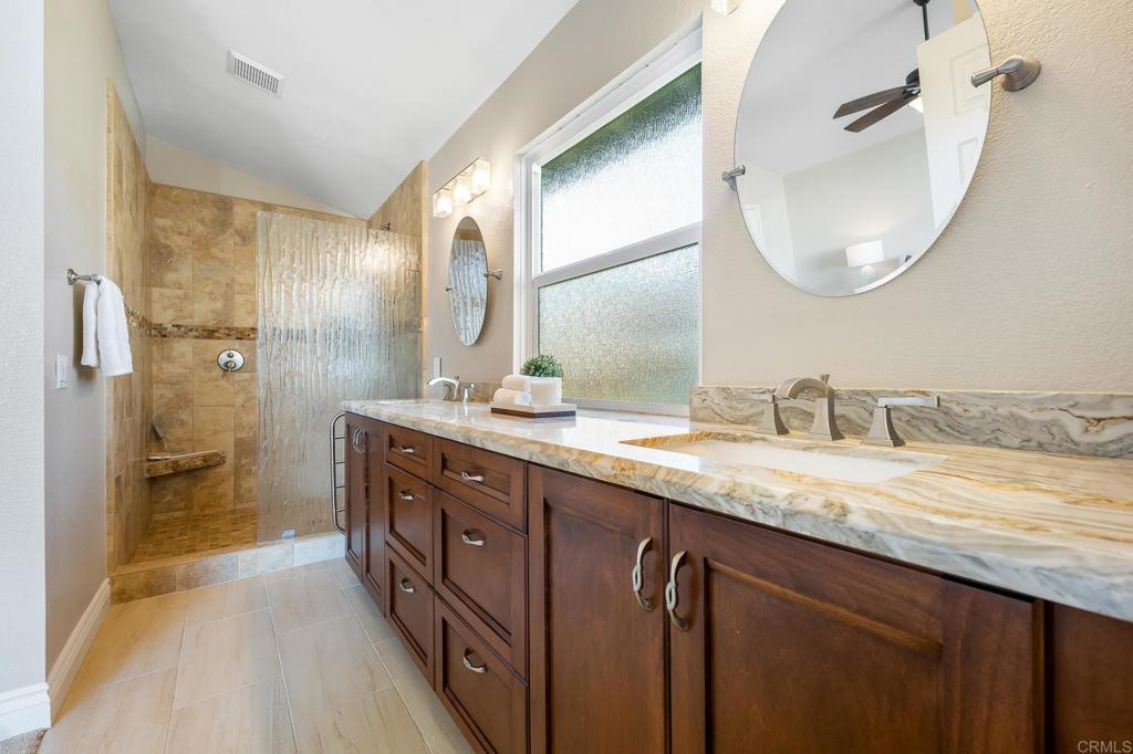 1592 Hawk View Drive Encinitas, CA 92024 - Photo 28 of 55 a spacious bathroom with a granite countertop sink mirror and a shower