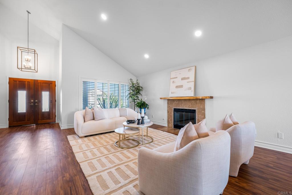 1592 Hawk View Drive Encinitas, CA 92024 - Photo 3 of 55 a living room with furniture a fireplace and wooden floor