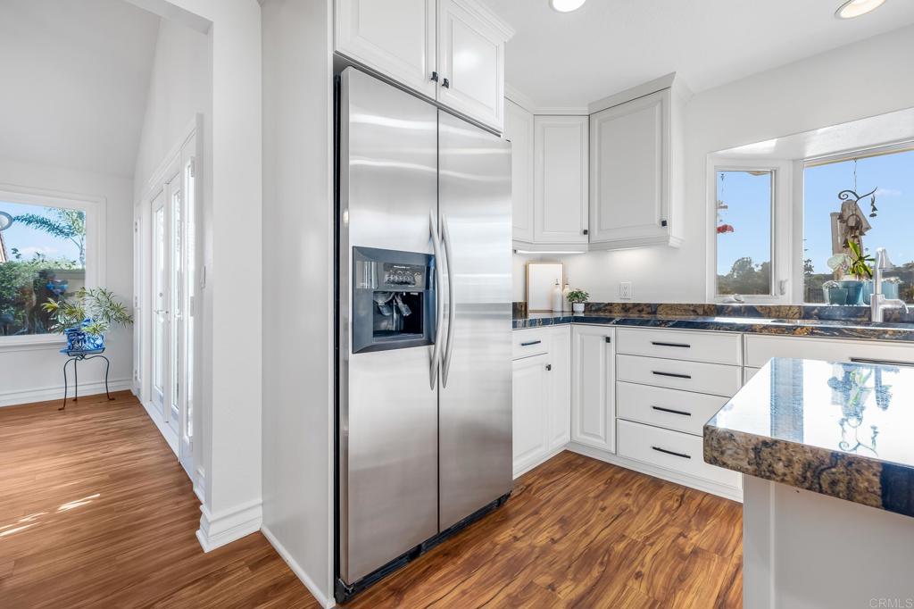 1592 Hawk View Drive Encinitas, CA 92024 - Photo 8 of 55 a kitchen with granite countertop a refrigerator sink and cabinets