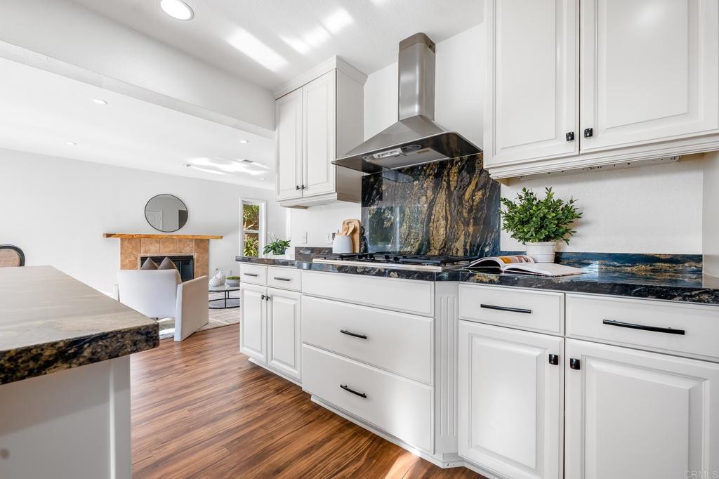 1592 Hawk View Drive Encinitas, CA 92024 - Photo 9 of 55 a kitchen with kitchen island granite countertop a sink cabinets and stainless steel appliances