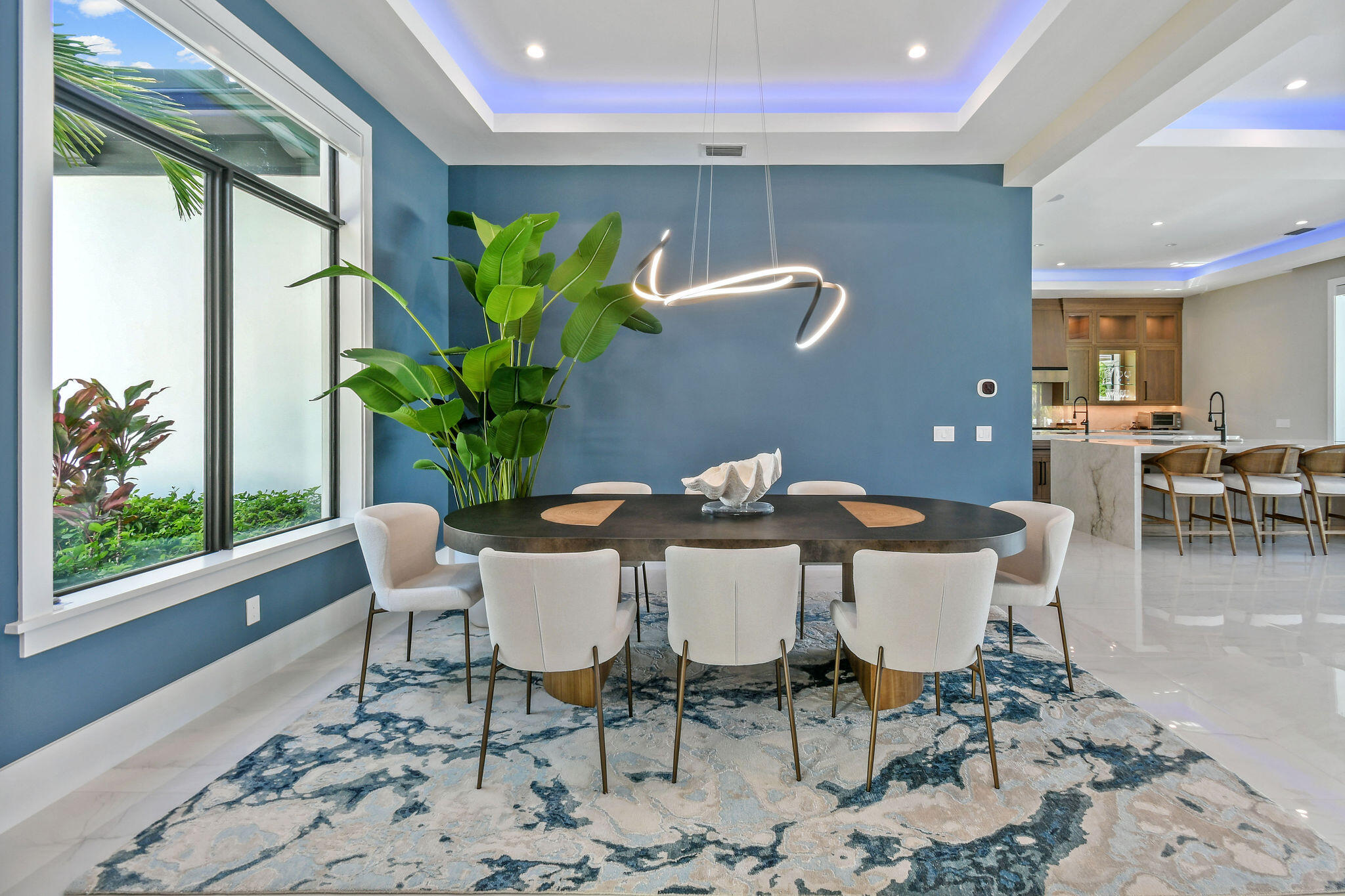 1060 Fairview Lane Singer Island, FL 33404 - Photo 19 of 82 a view of a dining room with furniture a potted plant and wooden floor