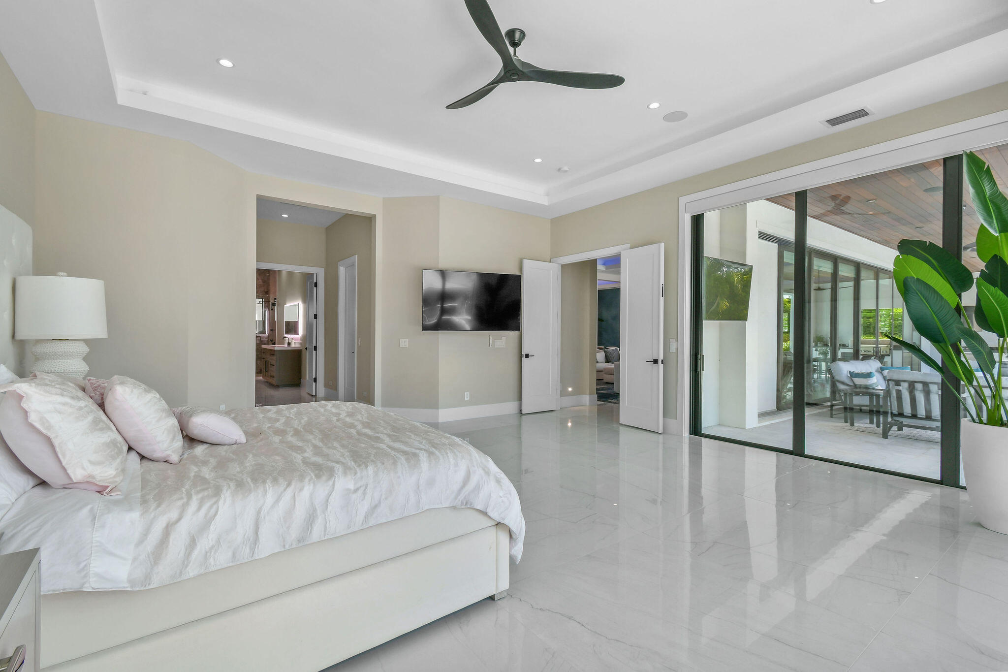 1060 Fairview Lane Singer Island, FL 33404 - Photo 24 of 82 a bedroom with a large bed and a chandelier