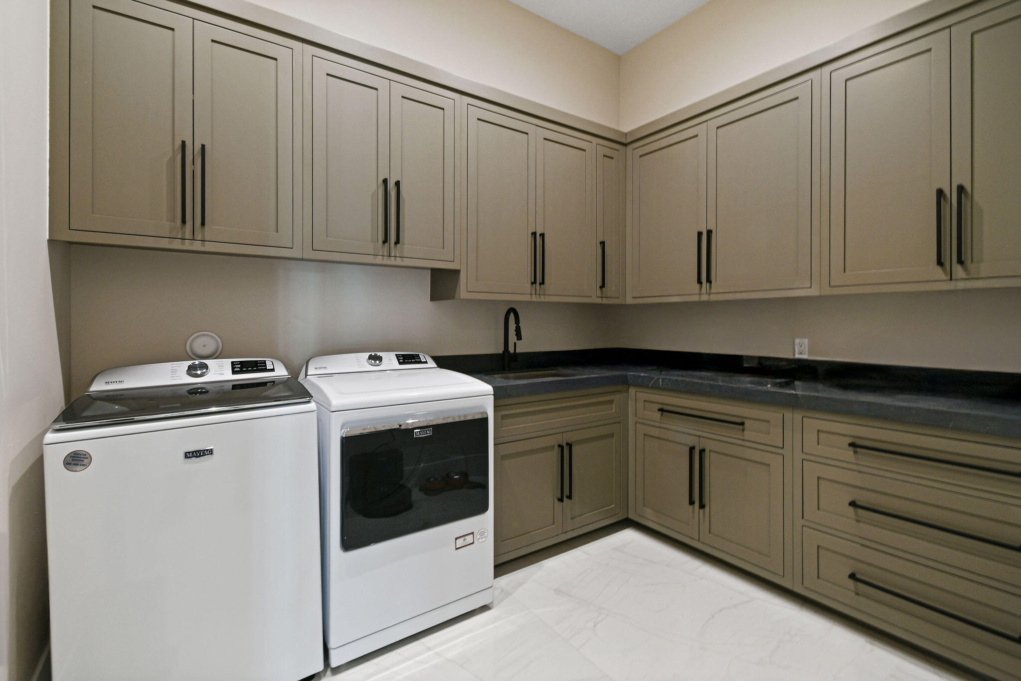 1060 Fairview Lane Singer Island, FL 33404 - Photo 31 of 82 a kitchen with granite countertop white cabinets and sink