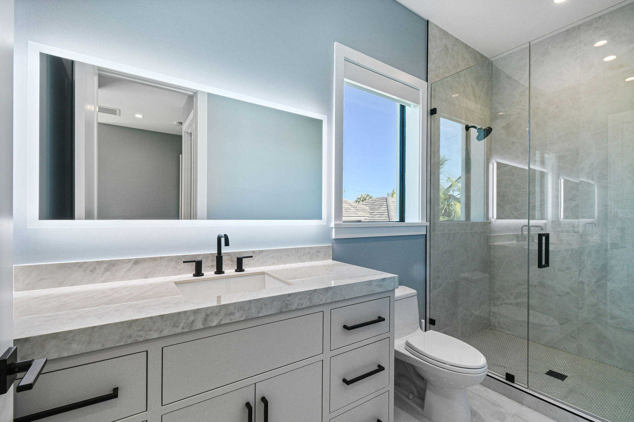1060 Fairview Lane Singer Island, FL 33404 - Photo 50 of 82 a bathroom with a shower sink vanity mirror and toilet