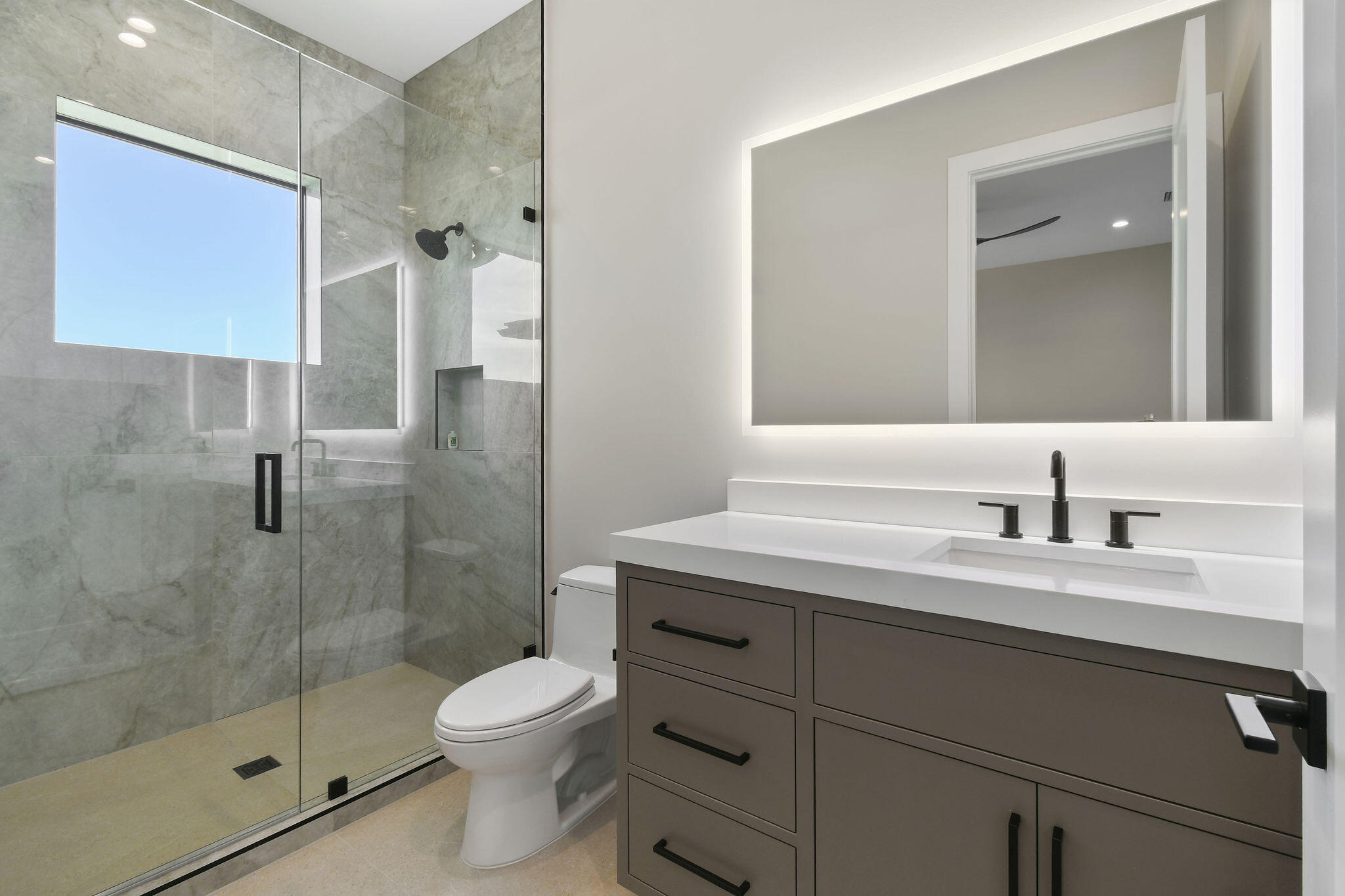 1060 Fairview Lane Singer Island, FL 33404 - Photo 57 of 82 a bathroom with a shower sink vanity mirror and toilet