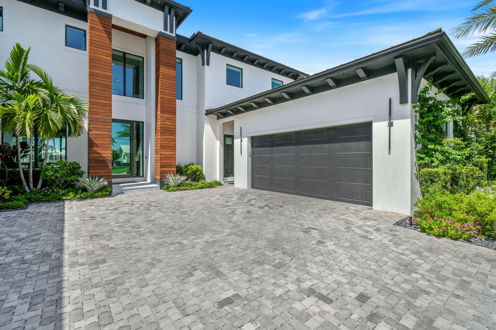 1060 Fairview Lane Singer Island, FL 33404 - Photo 6 of 82 a front view of a house with a yard and garage