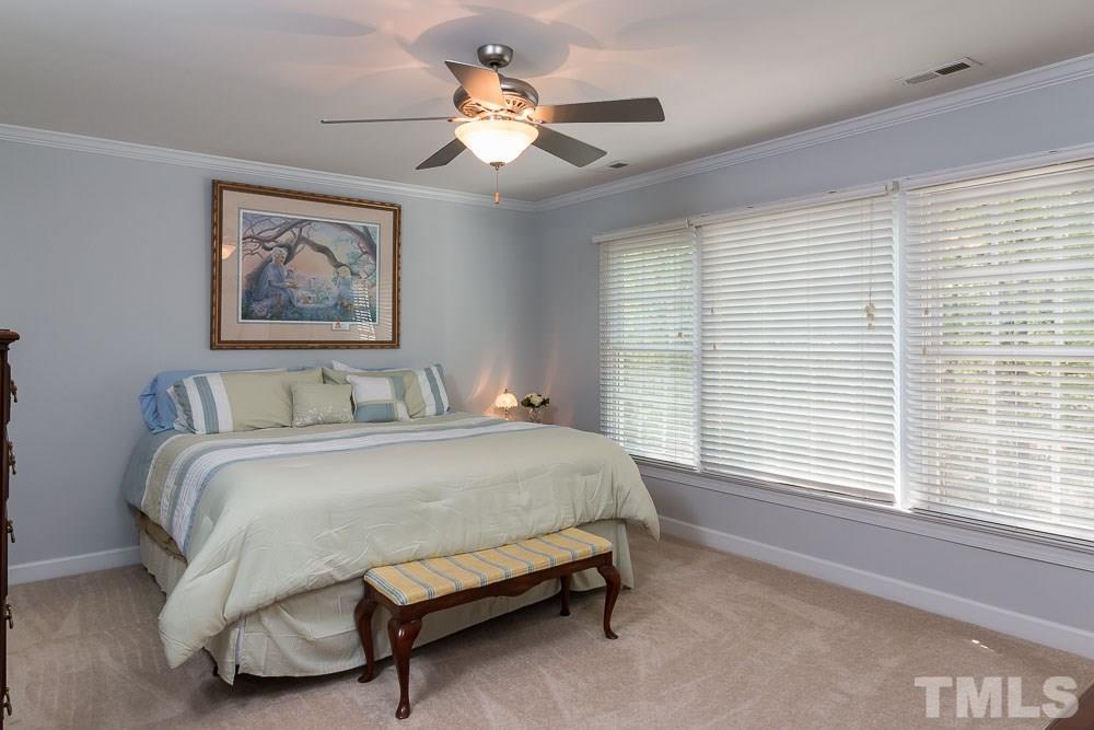 2908 Sunnystone Way Raleigh, NC 27613 - Photo 11 of 25 a spacious bedroom with a bed and a window