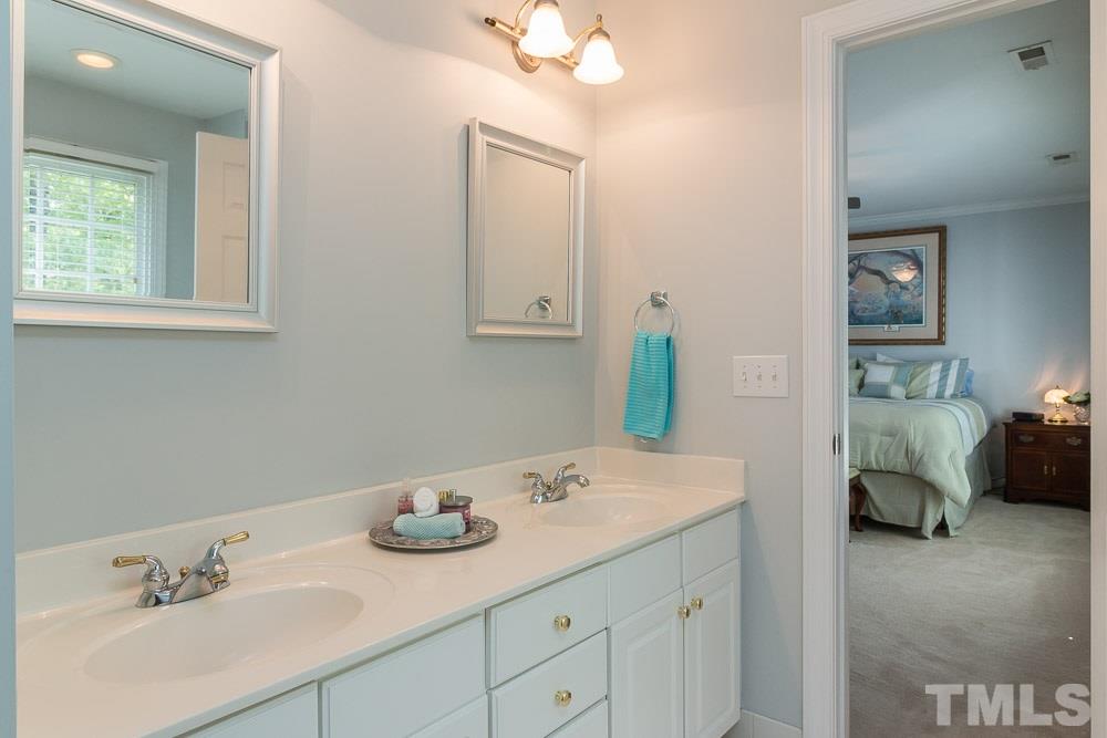 2908 Sunnystone Way Raleigh, NC 27613 - Photo 12 of 25 a bathroom with a sink and a mirror