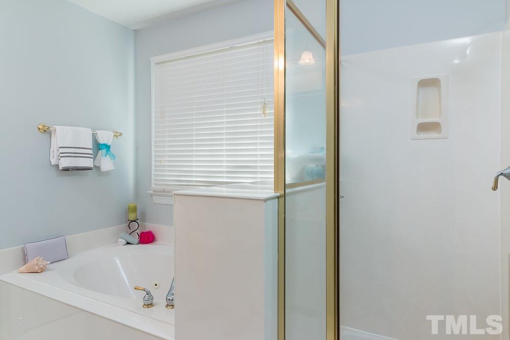 2908 Sunnystone Way Raleigh, NC 27613 - Photo 13 of 25 a bathroom with a bathtub and shower
