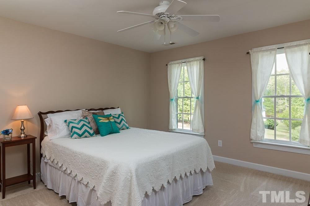 2908 Sunnystone Way Raleigh, NC 27613 - Photo 15 of 25 a bedroom with a bed and window