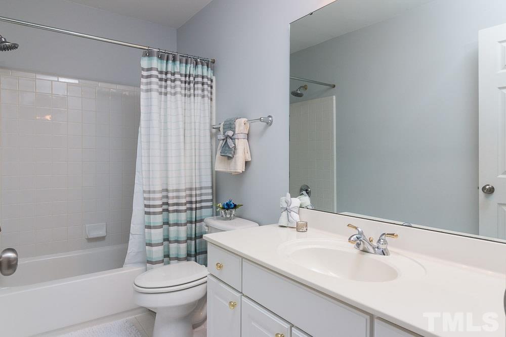 2908 Sunnystone Way Raleigh, NC 27613 - Photo 17 of 25 a bathroom with a sink a toilet and shower