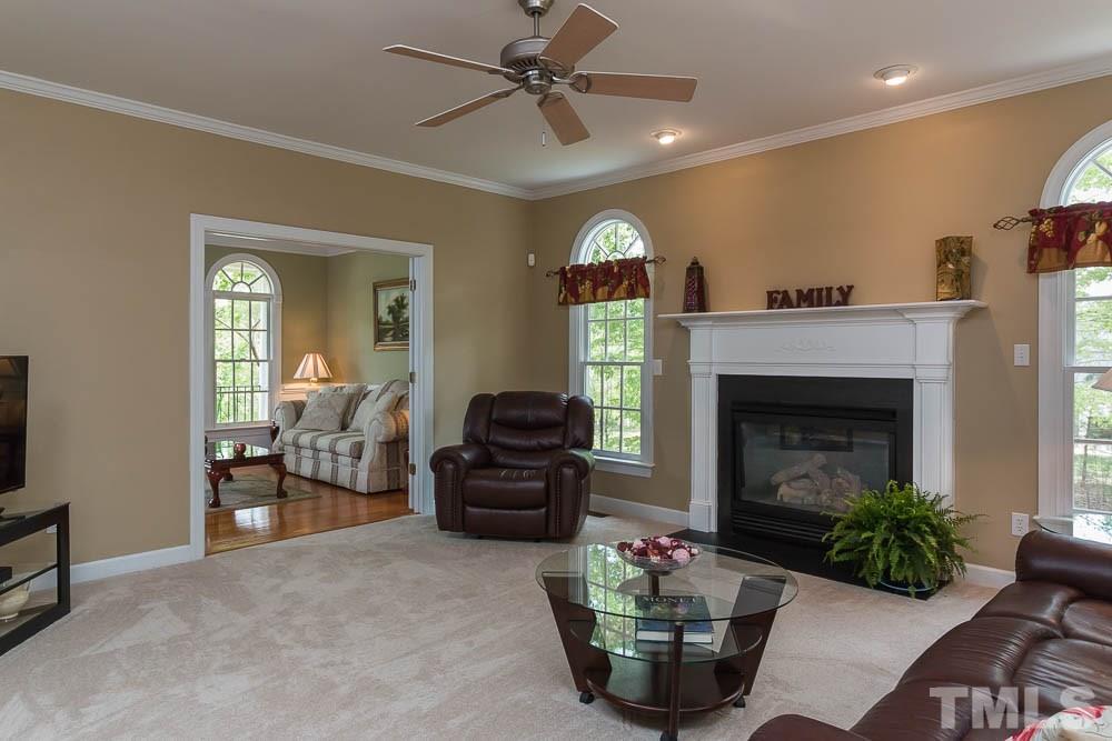 2908 Sunnystone Way Raleigh, NC 27613 - Photo 19 of 25 a living room with furniture and a fireplace