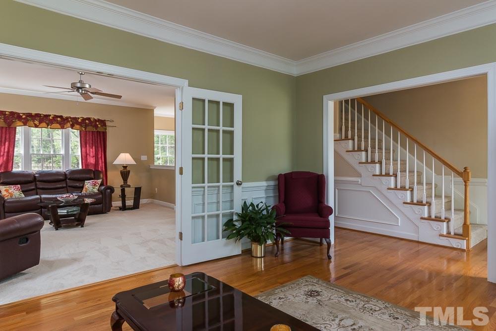 2908 Sunnystone Way Raleigh, NC 27613 - Photo 5 of 25 a living room with furniture and a flat screen tv