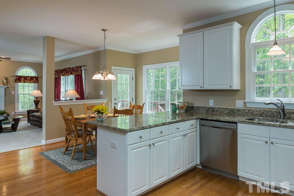 2908 Sunnystone Way Raleigh, NC 27613 - Photo 10 of 25 a kitchen with a sink cabinets and wooden floor