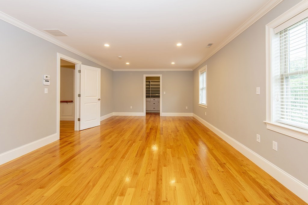 33 Liberty Avenue Lexington, MA 02420 - Photo 11 of 30 a view of empty room with wooden floor and windows