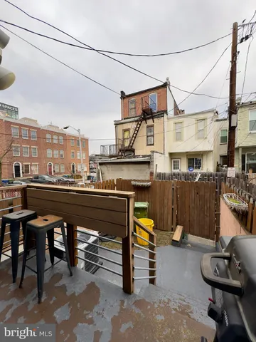 a view of a chairs and tables in the back yard of the house