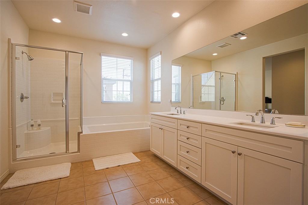 1509 Granada Road Upland, CA 91786 - Photo 18 of 31 a spacious bathroom with a mirror a shower and a sink