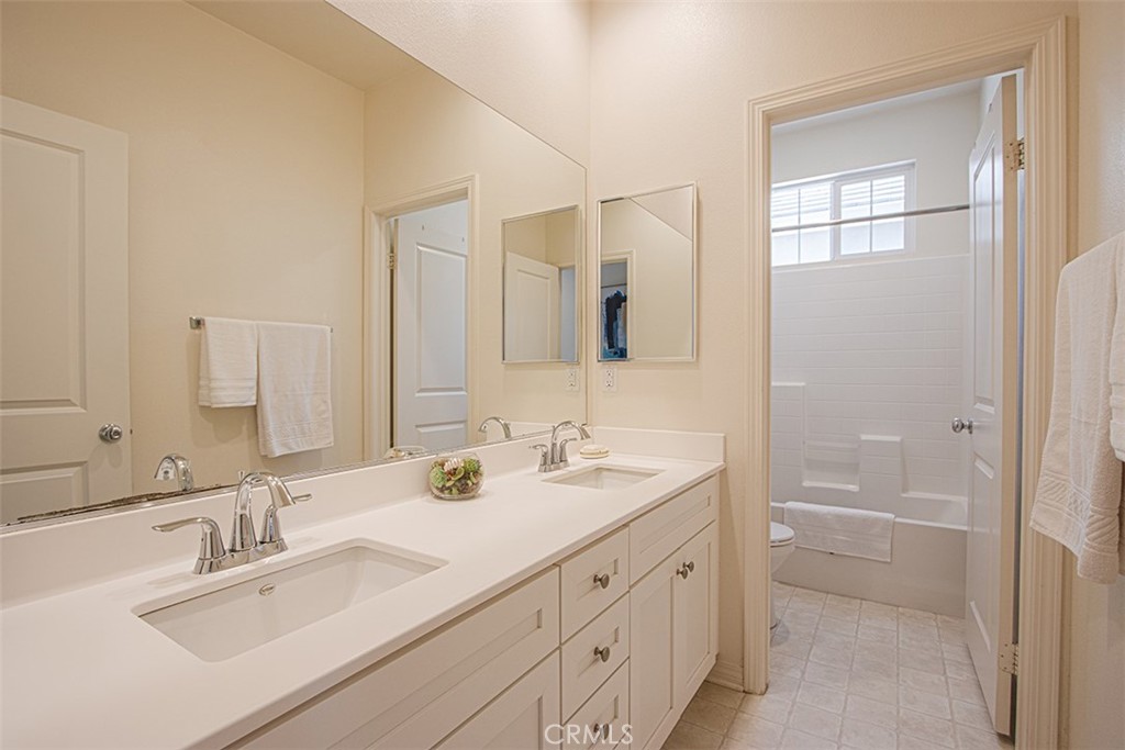 1509 Granada Road Upland, CA 91786 - Photo 19 of 31 a bathroom with 2 sink tub and a mirror