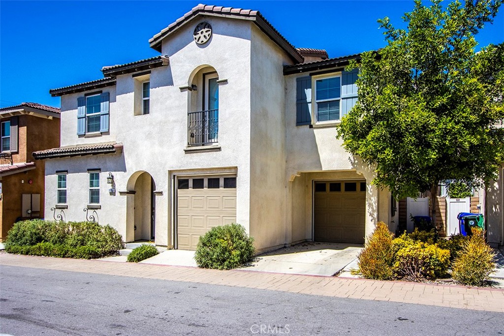 1509 Granada Road Upland, CA 91786 - Photo 24 of 31 a front view of a house with a yard and garage