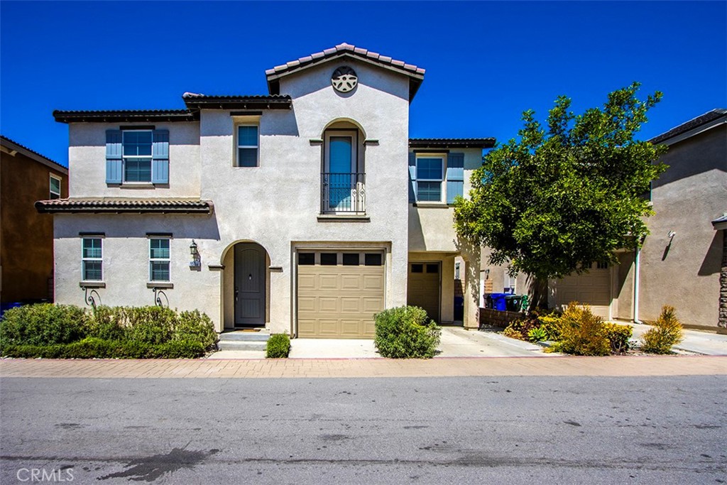 1509 Granada Road Upland, CA 91786 - Photo 25 of 31 a front view of a house with a yard and garage