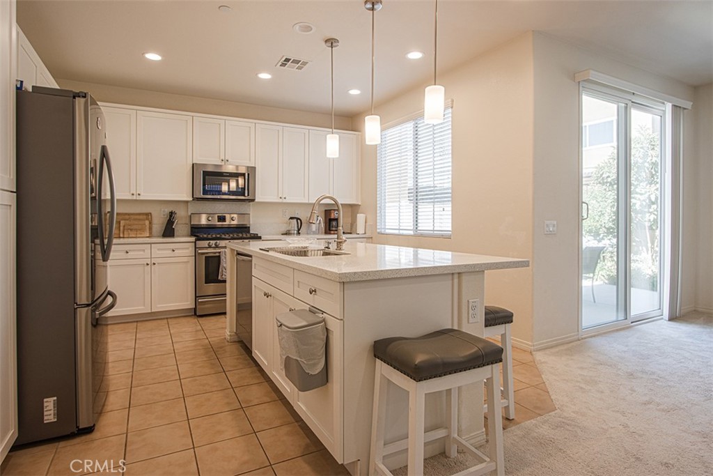 1509 Granada Road Upland, CA 91786 - Photo 6 of 31 a kitchen with stainless steel appliances a stove a sink and a refrigerator