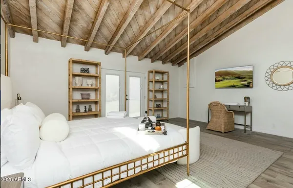 a bathroom with a granite countertop sink a toilet a mirror and shower