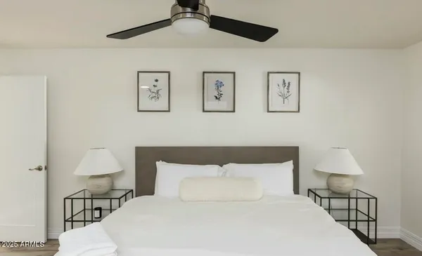 a bedroom with a bed and wooden floor