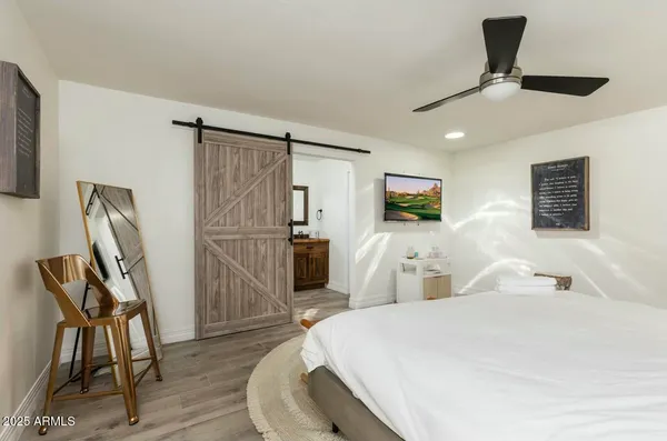 a bedroom with a bed and a lamp on table