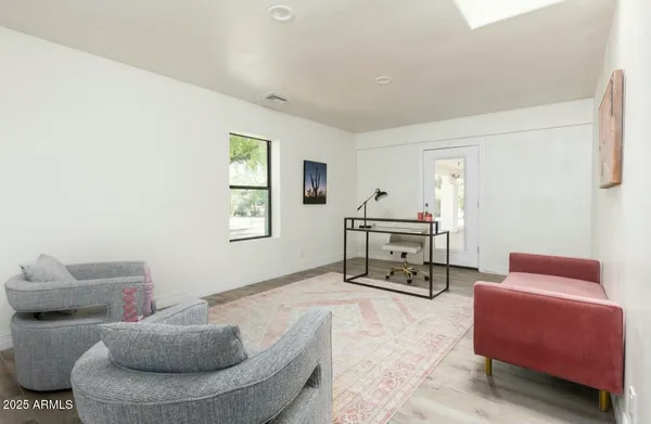 a backyard of a house with a yard and outdoor seating