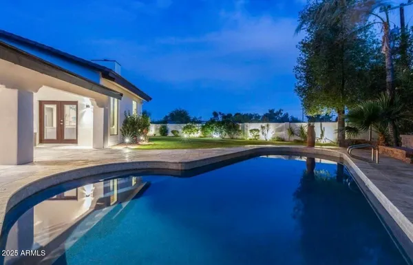 a view of a house with backyard and sitting area