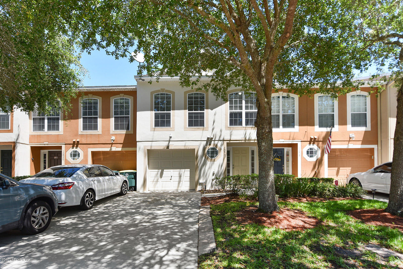a front view of a house with a yard and porch