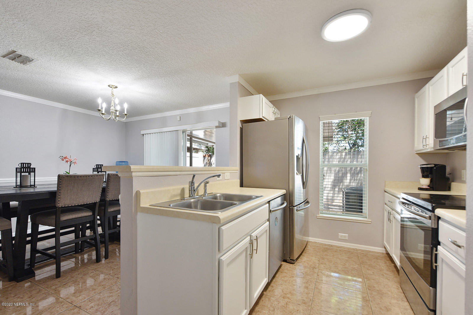 10543 Autumn Trace Road Jacksonville, FL 32257 - Photo 11 of 25 a kitchen that has a lot of cabinets in it and stainless steel appliances