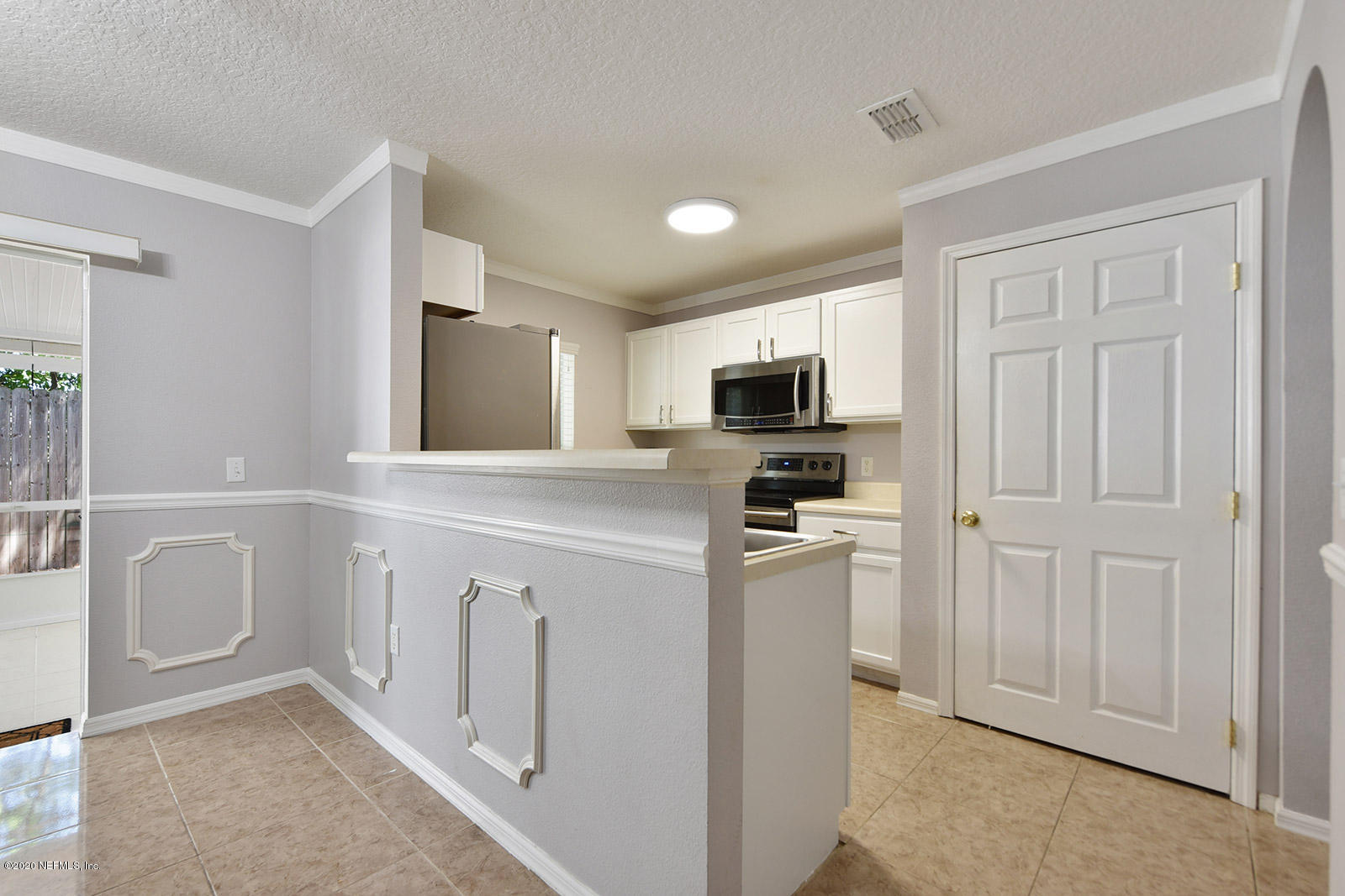 10543 Autumn Trace Road Jacksonville, FL 32257 - Photo 12 of 25 a kitchen with white cabinets and white appliances