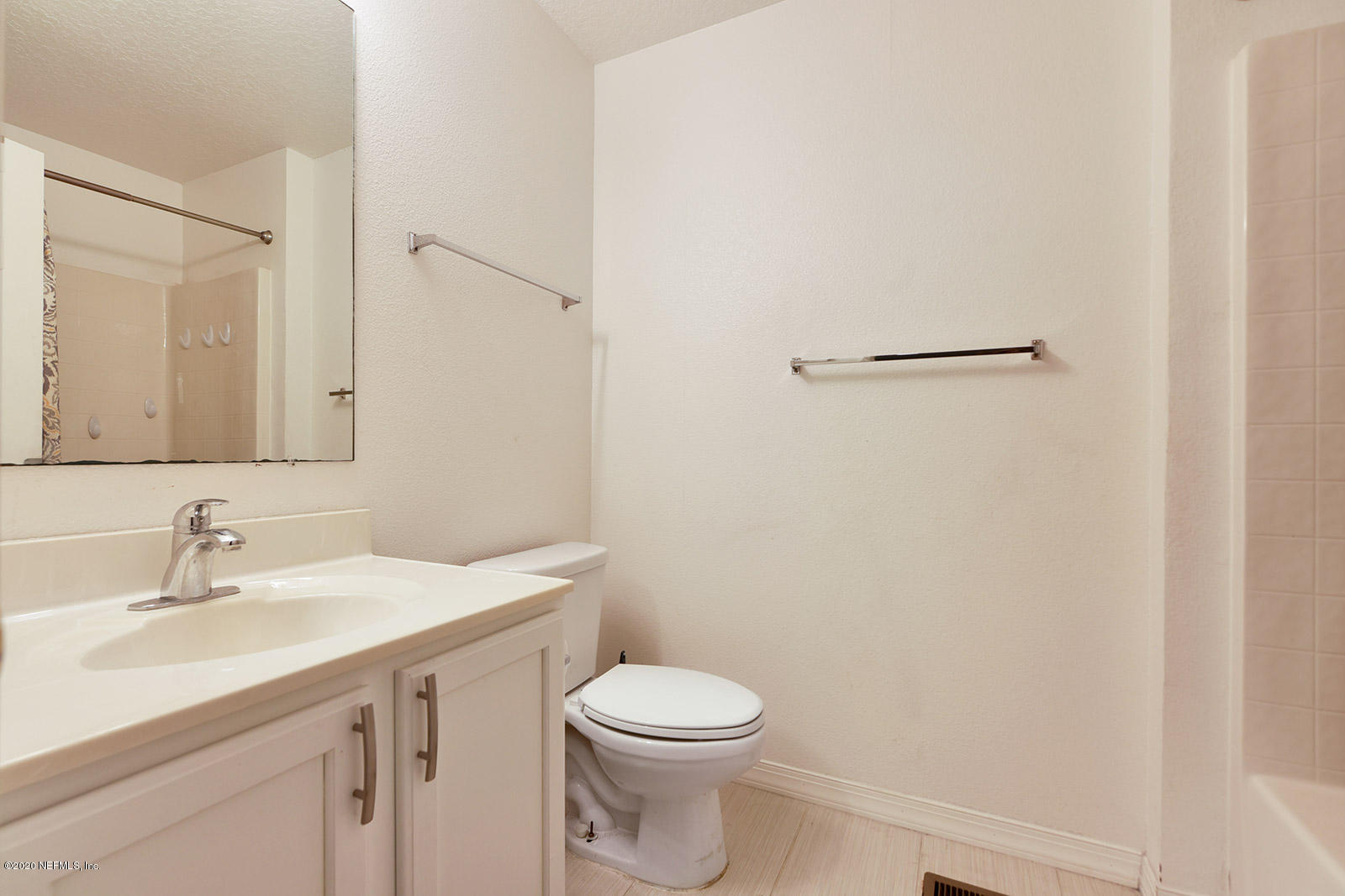 10543 Autumn Trace Road Jacksonville, FL 32257 - Photo 21 of 25 a bathroom with a toilet a sink a vanity and mirror